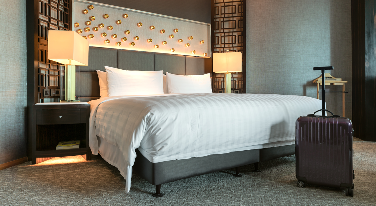 Hotel bedroom with suitcase