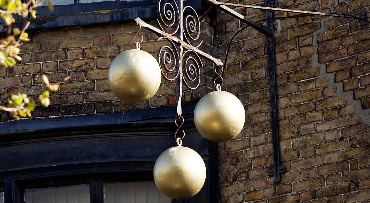 Pawnbroker sign next to brick wall
