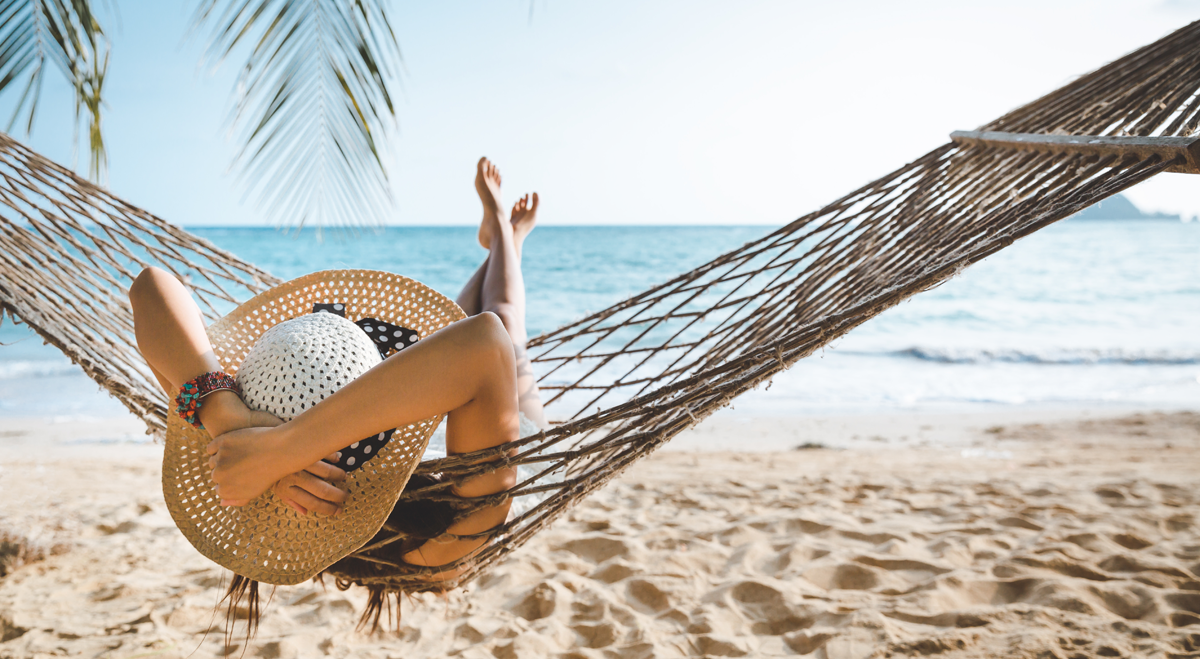 Woman in hammock on beach holiday