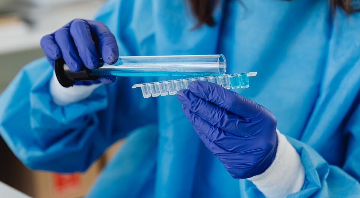 Researcher pouring liquid into vials