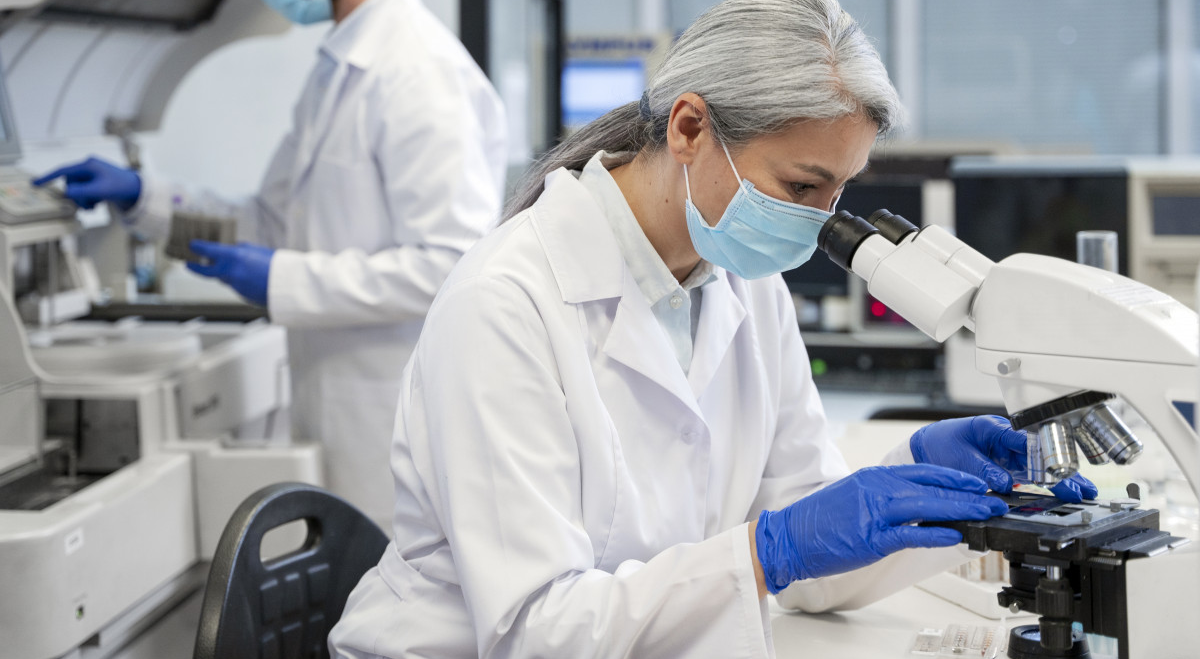 Researcher looking through microscope