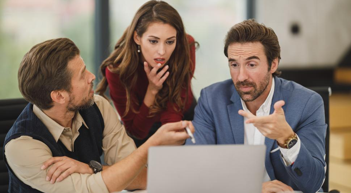 Office workers looking at a computer