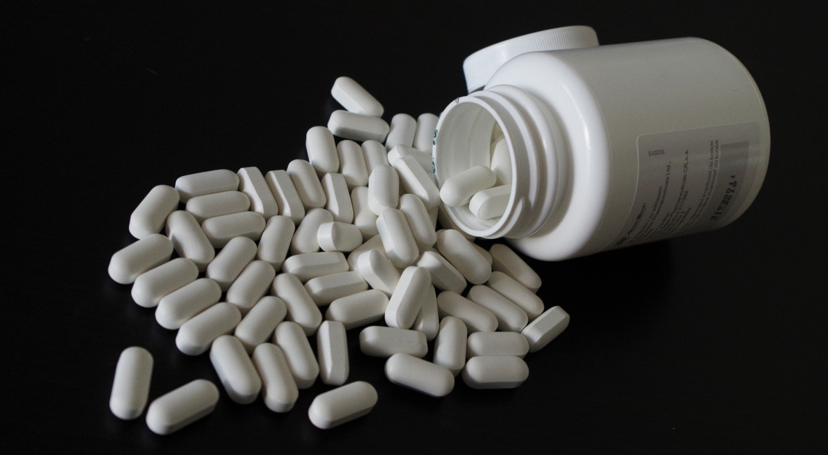 Pills spilling out of a container