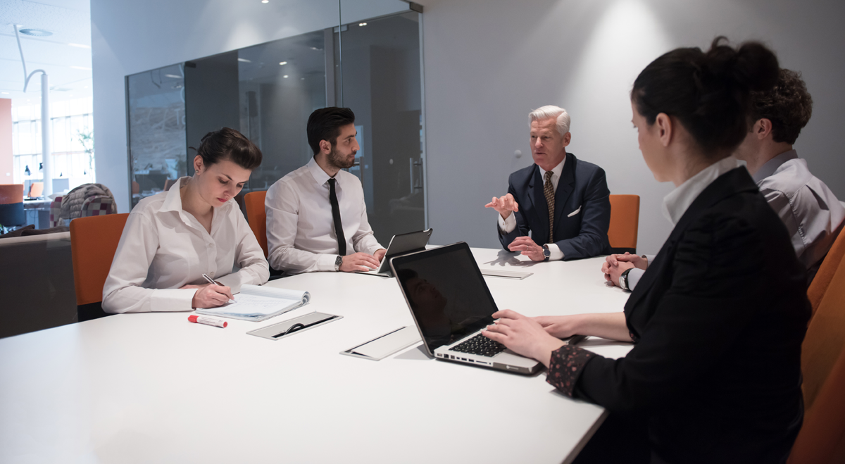 People with computers at a meeting