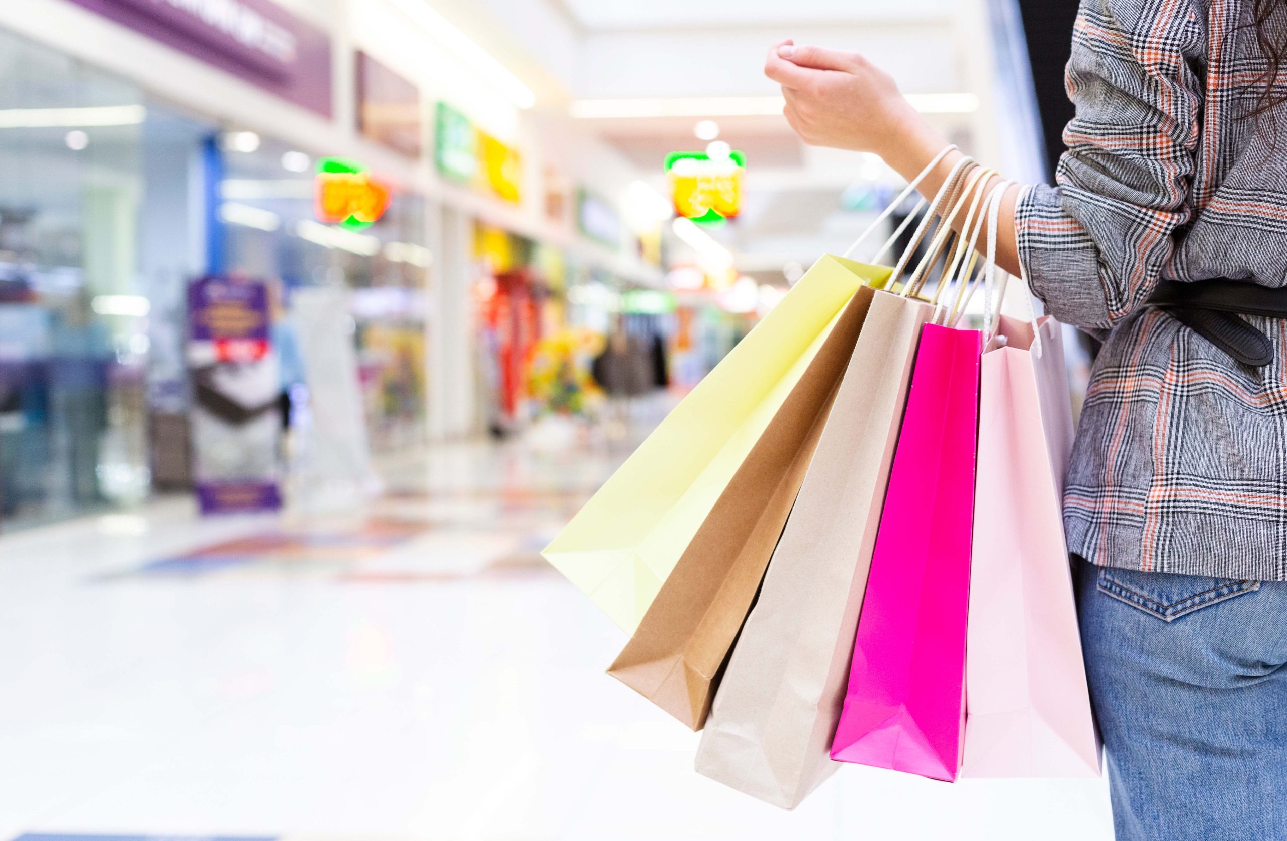 Woman carrying bags in retail mall