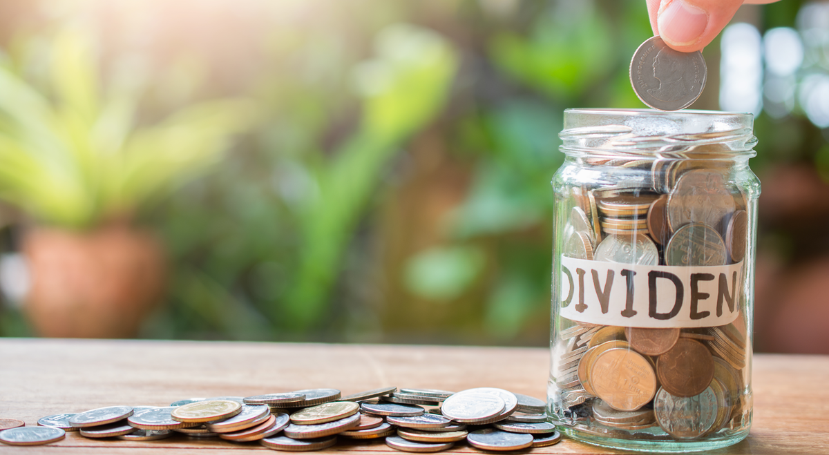 Coins being added to a jar to indicate dividends